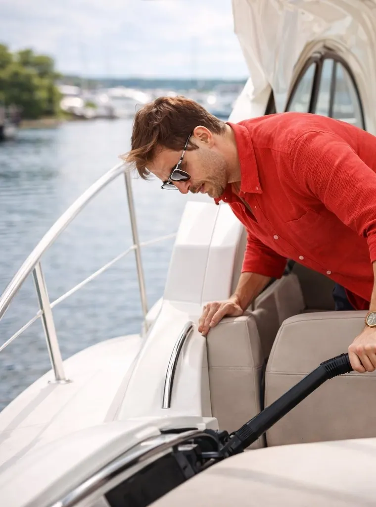 Vacuuming the cabin seating of a boat with a built-in central vacuum hose